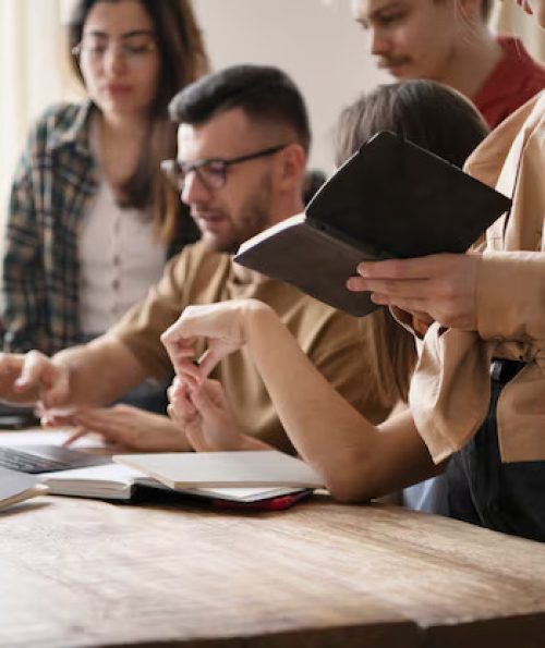 colleagues-reading-using-laptop-study-session_23-2149285398